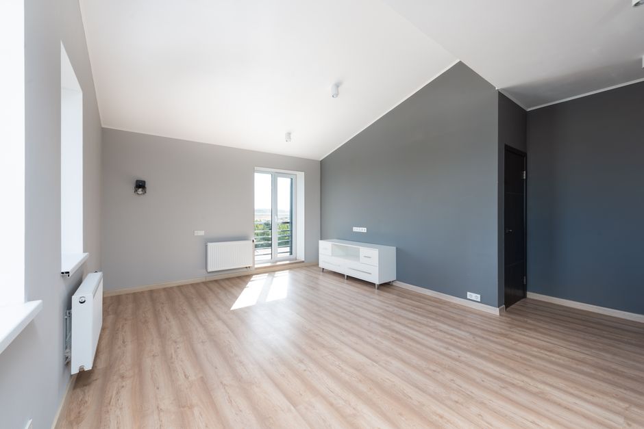 Repainted living room with light neutral walls and white trim