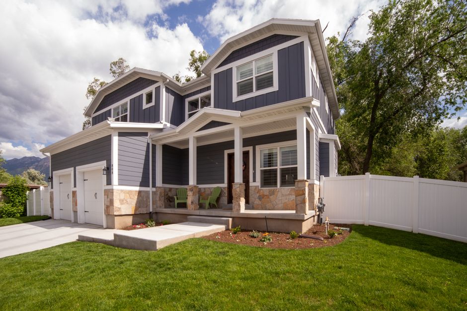 Two-story house exterior with fresh paint on siding and trim